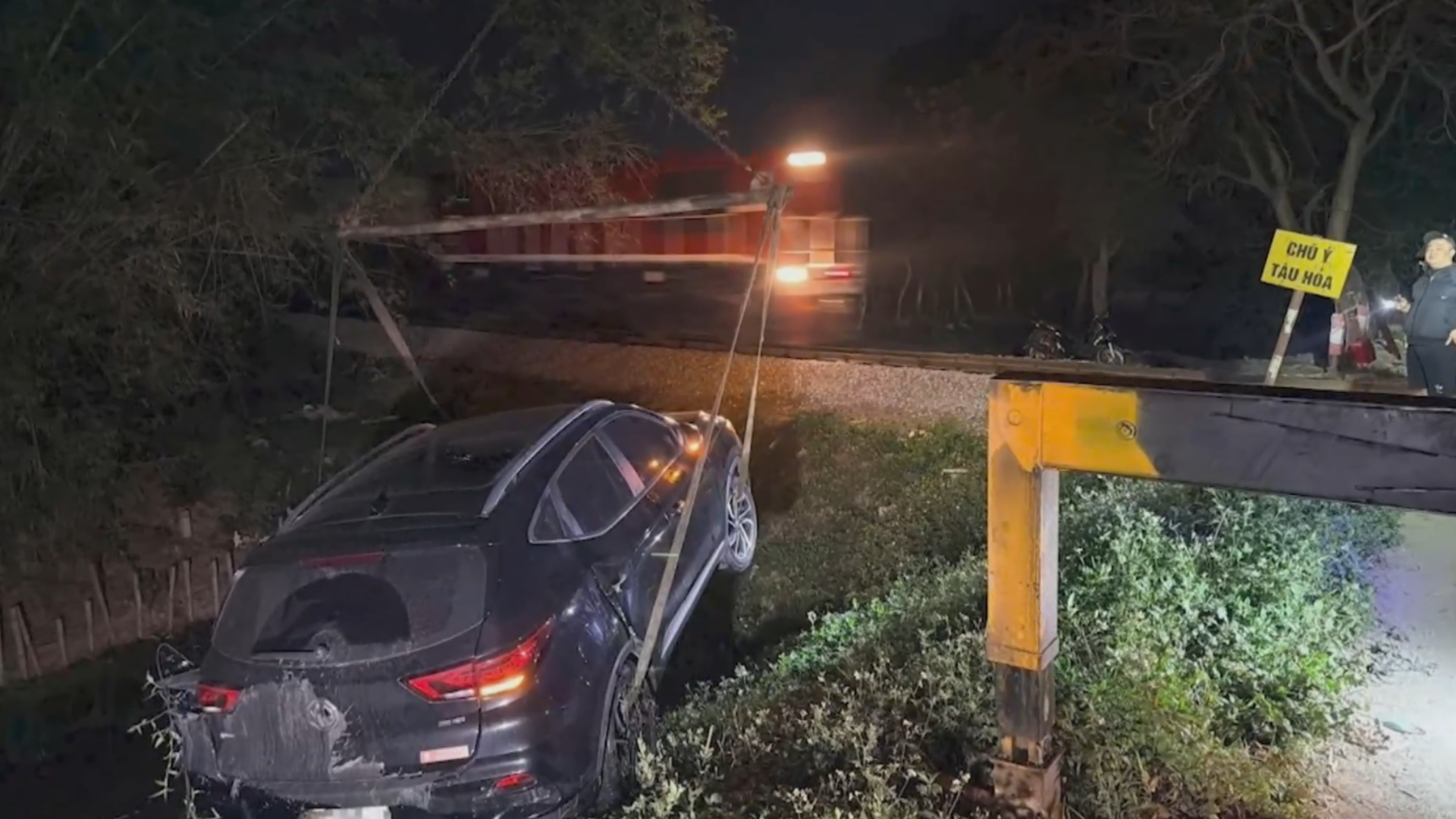 Tàu hỏa hất văng ô tô xuống mương nước ở Hà Nội 